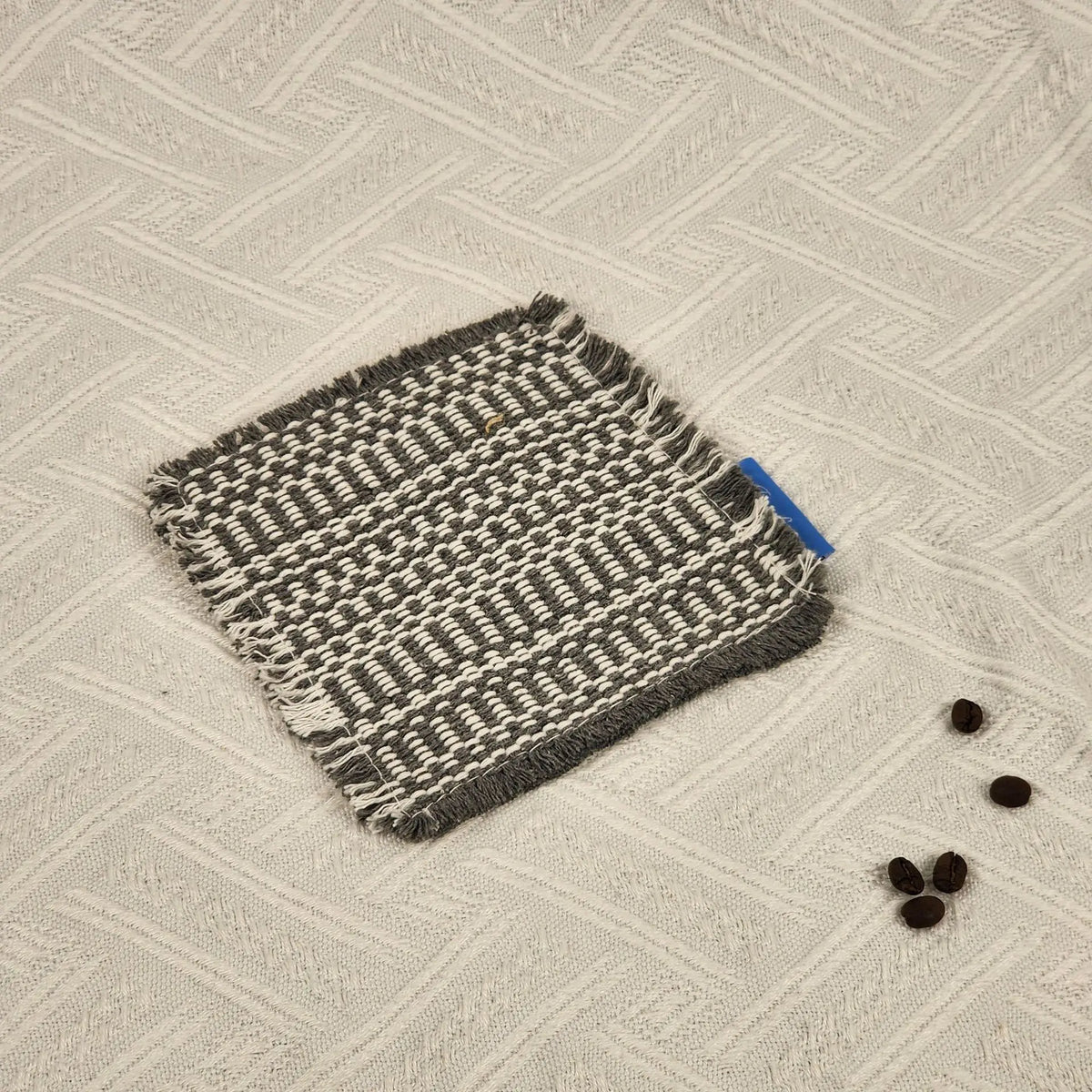Vintage-inspired, tassel-trimmed woven coasters. checkered square fabric trivets, perfect for coffee, tea, and more Quake Gray