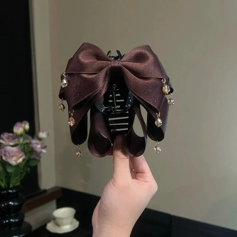 Elegant Sparkling Bow Hair Claw with Dangling Crystal Charms for Women Stylish Hair Accessory for Evening Parties and Daily Look Quake